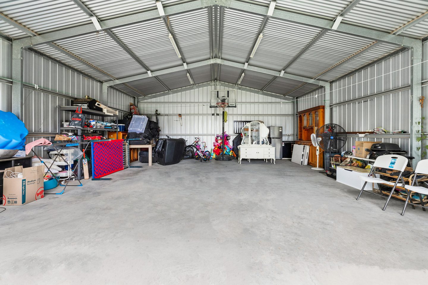 Interior of the large shed showing the concrete floor and open central space