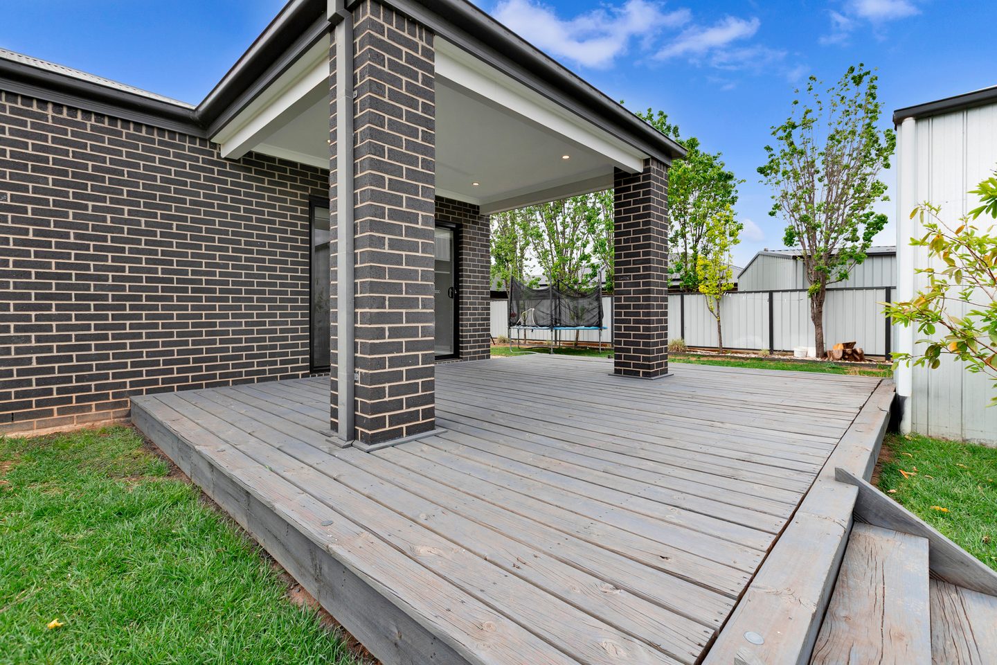 Rear deck beside the brick exterior