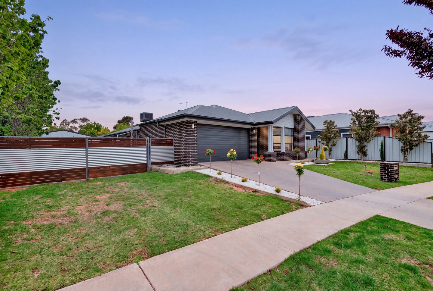 Wide view of the front garden at dusk