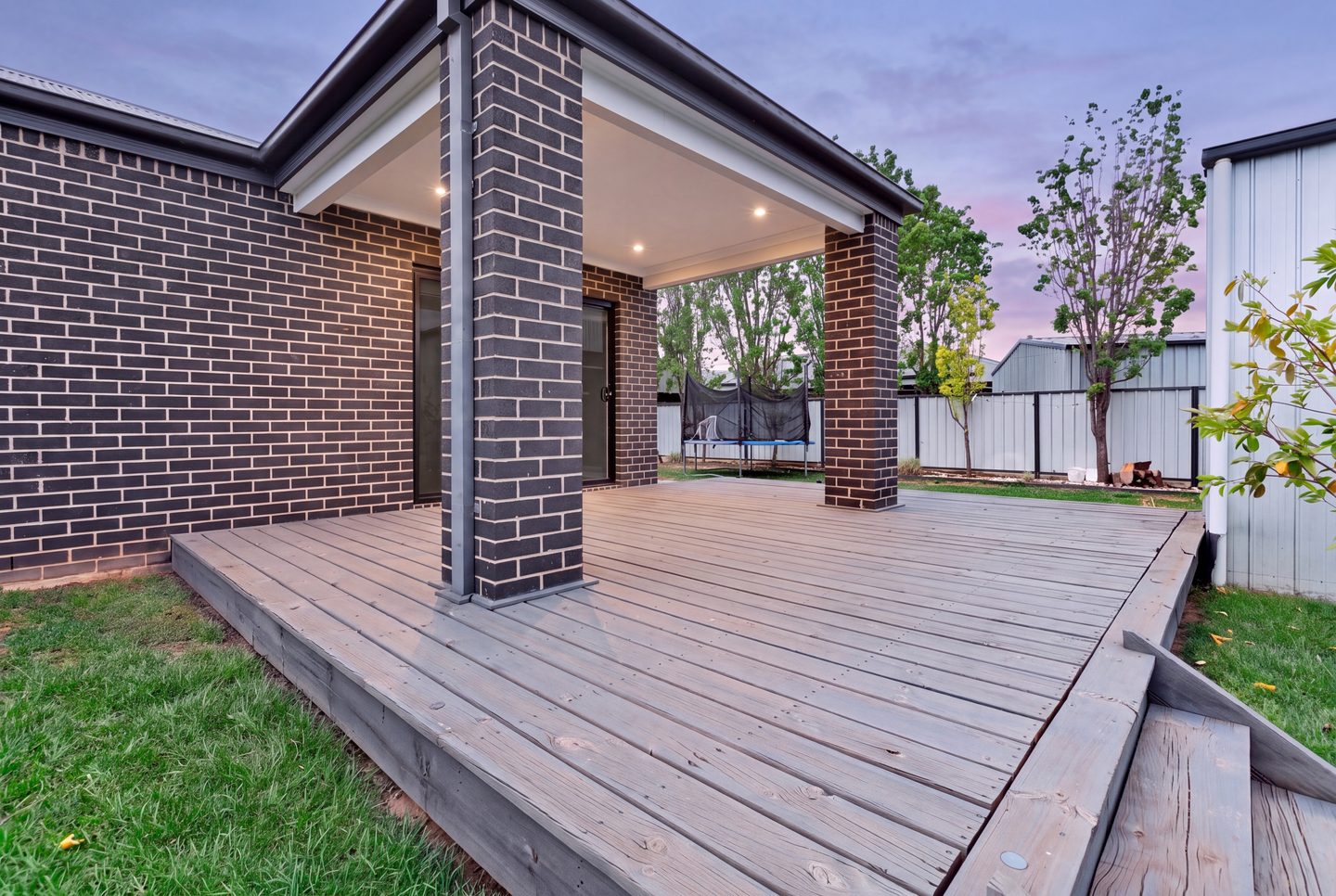 Rear deck with a covered alfresco area and steps to the garden